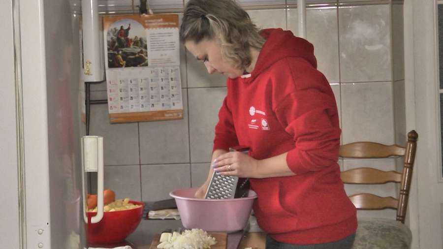 Волонтерка Олена Жигуліна за приготуванням їжі.